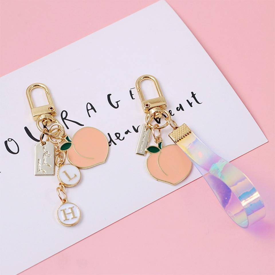 Изображение товара: Милые брелки для девочек, брелки для автомобильных ключей, сумки для ключей, Декор, розовый персиковый брелок, подвески для Airpods для Samsung Galaxy Buds